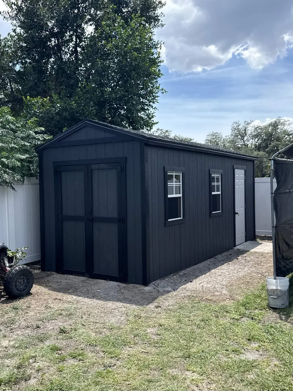 Charcoal custom workshop shed with contrasting white trim
